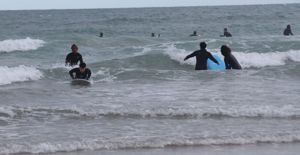 photo shows Solo Surfers having conversation during waiting for waves.
