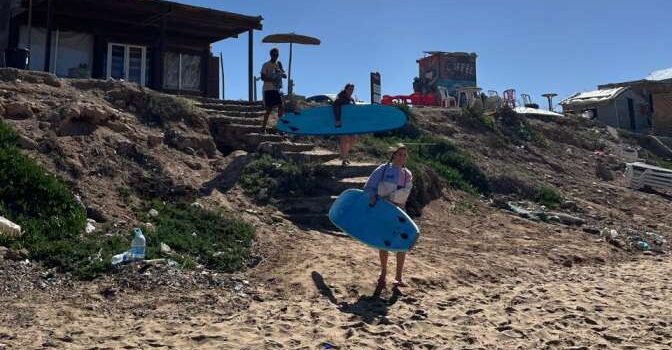 A Female Surfer Carrying a Board