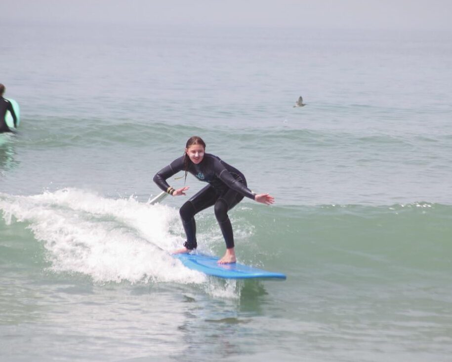 Female Surfer catching a wave