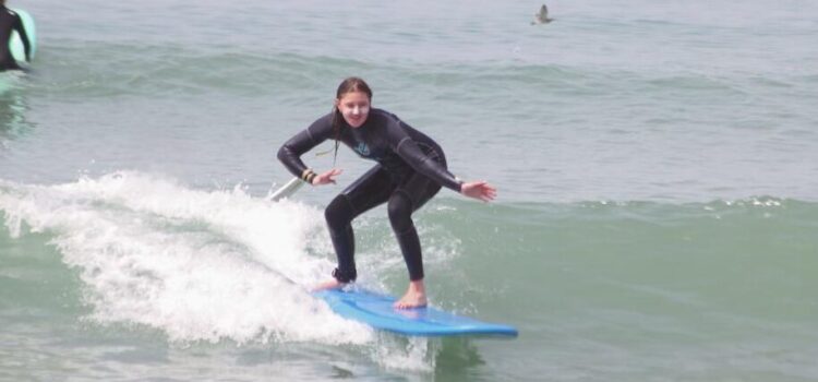 Female Surfer catching a wave