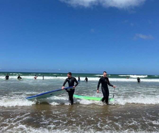 Surfers coming out of the water