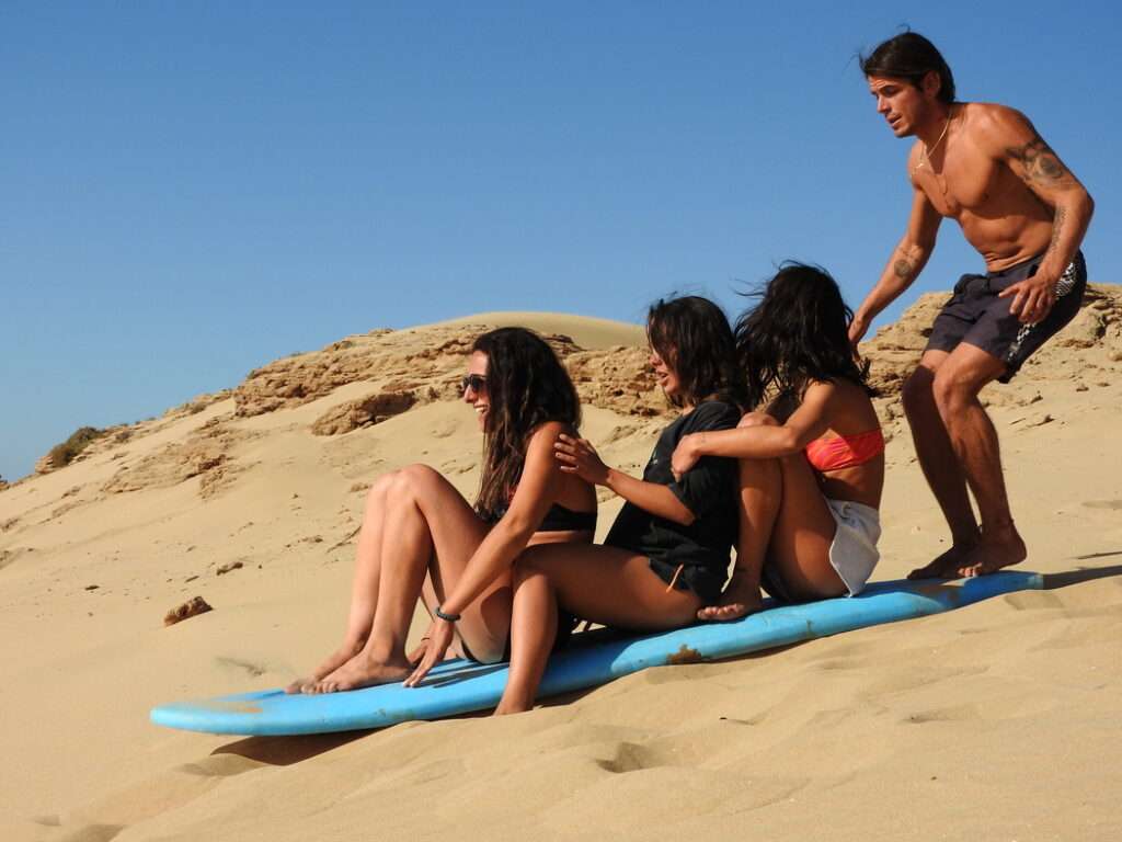 people enjoying sand surfing by Original Surf Morocco